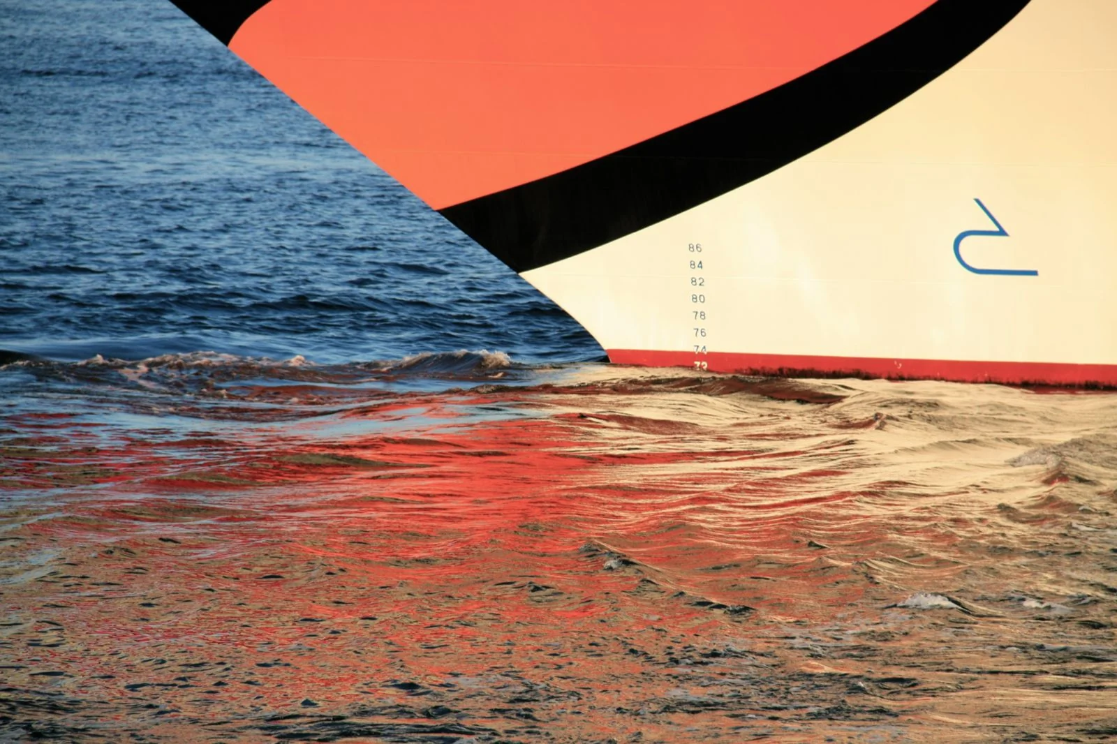 Colourful sail crossing the sea at sunset